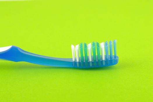 Tooth-brush over bright green