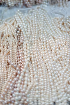 Bunch of pearl necklaces close-up in a street market in China