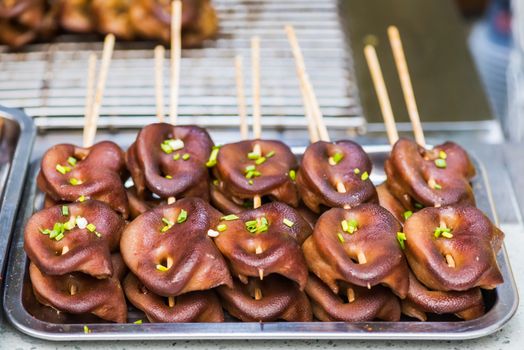 Pig grilled snouts skewers in a street market in China