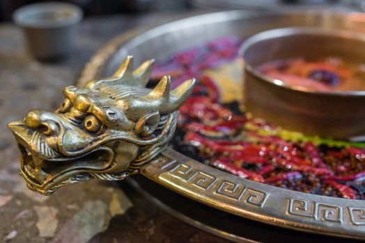 Chengdu Sichuan Hot Pot close up with dragon head sculpted handles, Chenggdu, Sichuan Province, China