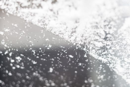 Snow on a car's front windshield selective focus