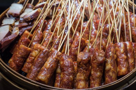 Sausages skewers with raw meat in a plate in a chinese market, Chengdu, China