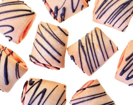 Cookies rolls with strawberry jam and chocolate icing top view isolated on a white background.
