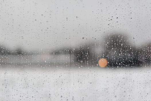 Water drops on a window with a black and white blurred background