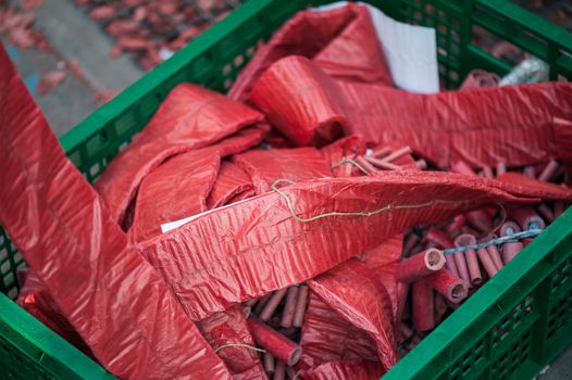 Stripes of red firecrackers in a green basket for the chinese new year