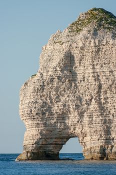 Natural stone arch on chalk cliffs with the sea in Etretat, Normandy, France