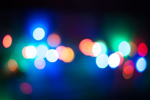 Multicolor defocused bokeh lights in the night background