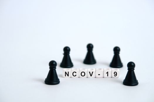 Pandemic coronavirus conceptual photography – stop spreading of COVID19 - word beads surrounded by chess pieces. Image Photo