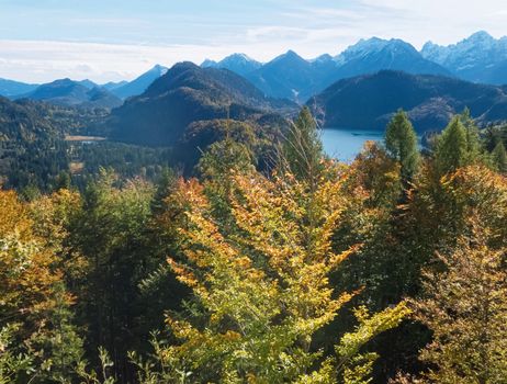 Beautiful nature of European Alps, landscape view of alpine mountains, lake and village on a sunny day, travel and destination scenery