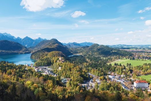 Beautiful nature of European Alps, landscape view of alpine mountains, lake and village on a sunny day, travel and destination scenery