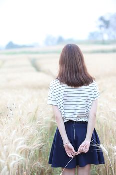 Young woman in wheat