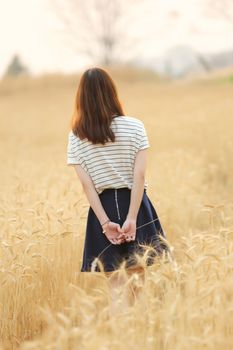 Young woman in wheat