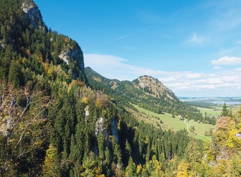 Beautiful nature of European Alps, landscape view of alpine mountains, lake and village on a sunny day, travel and destination scenery