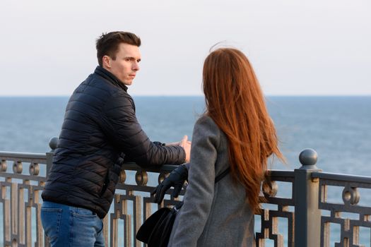 Two young people discuss the situation on the beach