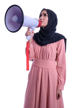 Young muslim woman in hijab clothes holds in hand bullhorn public address megaphone isolated on yellow background studio portrait. People religious lifestyle concept. Mock up copy space