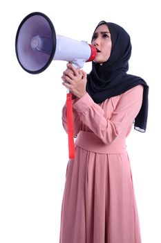 Young muslim woman in hijab clothes holds in hand bullhorn public address megaphone isolated on yellow background studio portrait. People religious lifestyle concept. Mock up copy space