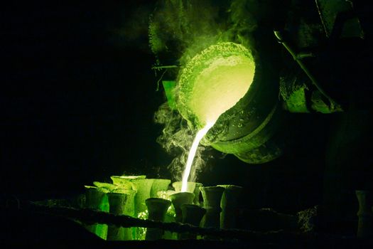 steel casting process toned green for magic potion or chemical or biohazard or radioactive waste illustration.