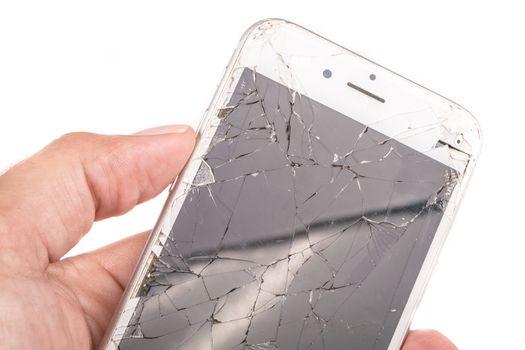 Paris, FRANCE - August 26, 2017: A man holds in his hand an iphone 6S of Apple Inc. whose screen is broken as a result of a violent fall