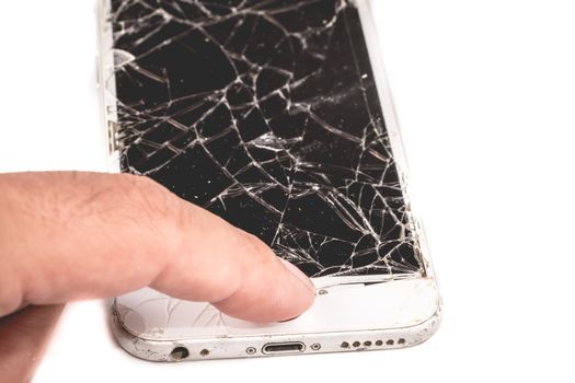 Paris, FRANCE - August 26, 2017: A man holds in his hand an iphone 6S of Apple Inc. whose screen is broken as a result of a violent fall