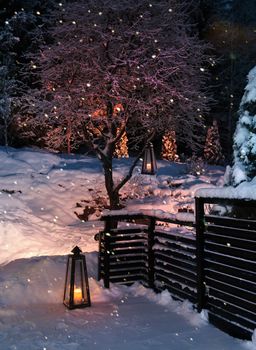 Lanterns in snowy winter garden yard snowfall