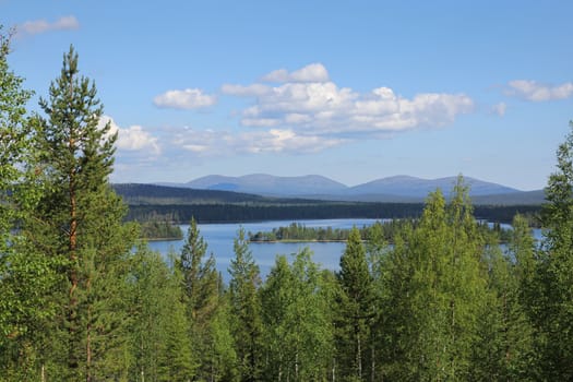 Finnish Lapland summer lake scenery with Pallastunturi fells on the horizon