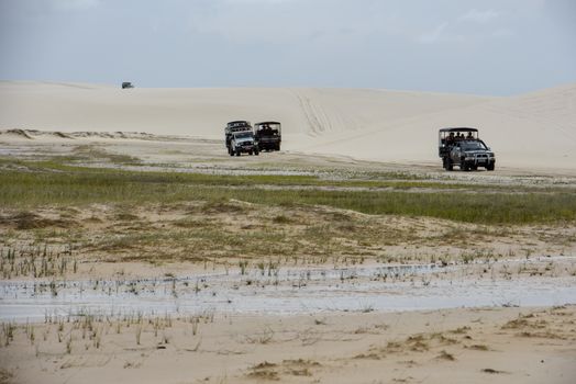 Atins, Brazil - 12 January 2019: tourist trucks on the dunes at Lencois Maranhenese National Park in Brazil