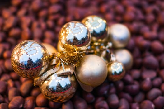 Shiny christmas balls decoration on fried chestnuts