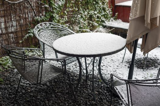 Steel garden table and chairs under the snow in Rotterdam, Netherlands