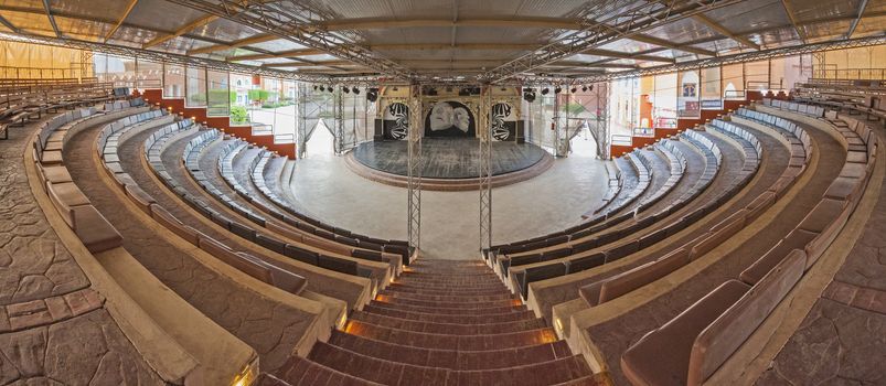 Panoramic view of the interior in large amphitheatre area with seating rows