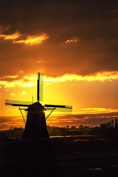 Warm and vibrant sunrise over the Unesco world heritage windmill in Leidschendam, Kinderdijk, Netherlands 