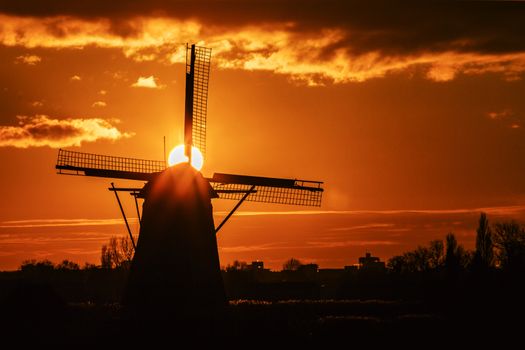 Warm and vibrant sunrise over the Unesco world heritage windmill in Leidschendam, Kinderdijk, Netherlands 