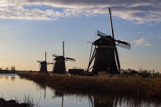 Warm and vibrant sunrise over the Unesco world heritage windmill in Leidschendam, Kinderdijk, Netherlands 