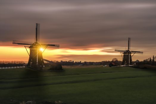 Warm and vibrant sunrise over the Unesco world heritage windmill in Leidschendam, Kinderdijk, Netherlands 