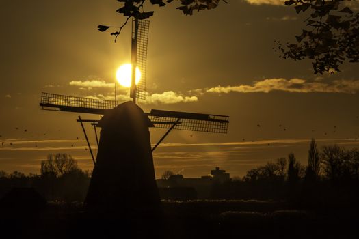 Warm and vibrant sunrise over the Unesco world heritage windmill in Leidschendam, Kinderdijk, Netherlands 