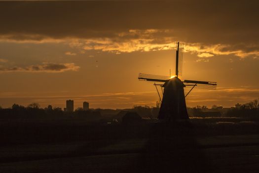 Warm and vibrant sunrise over the Unesco world heritage windmill in Leidschendam, Kinderdijk, Netherlands 
