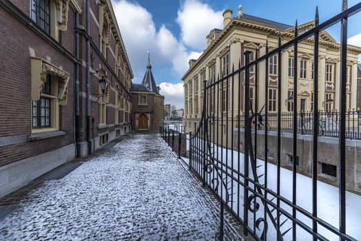 Snowy pathway in front of the Dutch parliament building and its frozen pond water