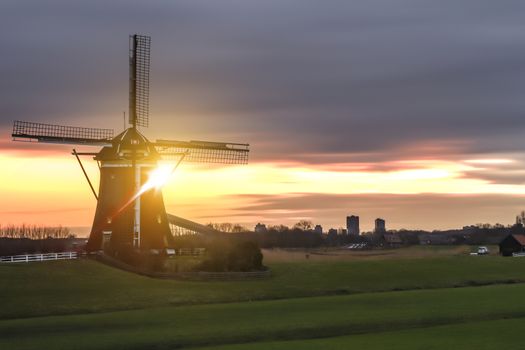 Warm and vibrant sunrise over the Unesco world heritage windmill in Leidschendam, Kinderdijk, Netherlands 