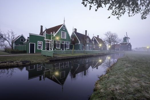 Beaucoutif typical Dutch wooden houses architecture mirrored on the calm canal of Zaanse Schans located at the North of Amsterdam, Netherlands