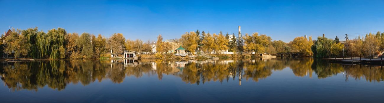 Autumn landscape with a lake and yellow trees in the village of Ivanki, Cherkasy region, Ukraine, on a sunny autumn evening