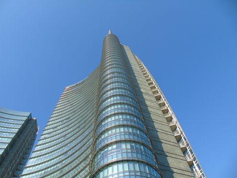 Milano, Italy - 02/14/2020: Amazing photography to the Skyscrapers of Milano in winter days with some people, a great blue sky and some details of the exterior part of the structure