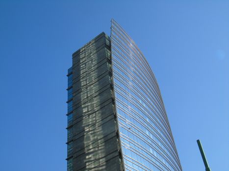 Milano, Italy - 02/14/2020: Amazing photography to the Skyscrapers of Milano in winter days with some people, a great blue sky and some details of the exterior part of the structure