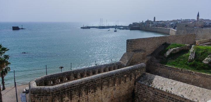 View of the city walls and the fishing harbor, the old city of Acre, Israel