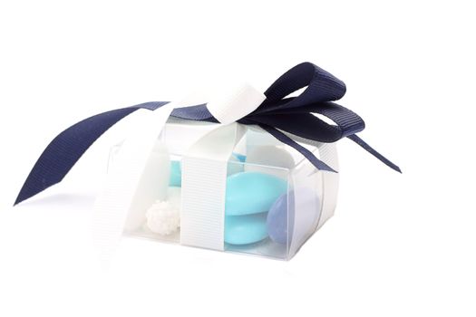 Blue and white sugared almonds in transparent plastic box