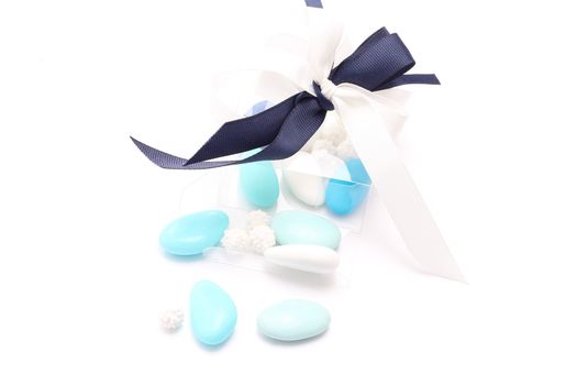 Blue and white sugared almonds in transparent plastic box