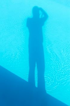 Shadow of photographer in the swimming pool