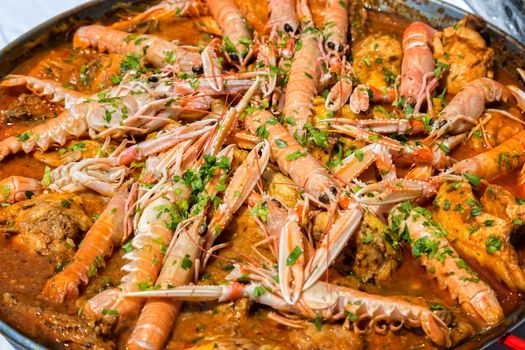 Paella with seafood and vegetables in a pan