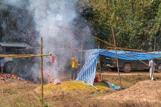 Prachinburi, Thailand - April 6, 2019 : Thai Chinese respect ancestors parents those died by food and burn fake money to sacrifice them at cemetery in Qingming Festival (Qing Ming), Tomb-Sweeping Day