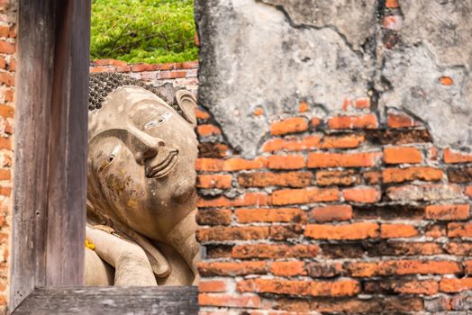 Ayutthaya Thailand June 13, 2020 : Reclining Buddha in the temple,Archaeological site,Pagoda Putthaisawan Temple Ayutthaya , Thailand
