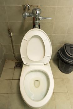 White ceramic toilet bowl, sanitary equipment in restroom