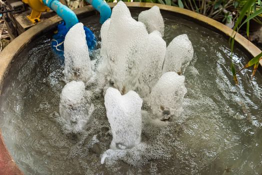 Small fountain at garden, Blue water flowing